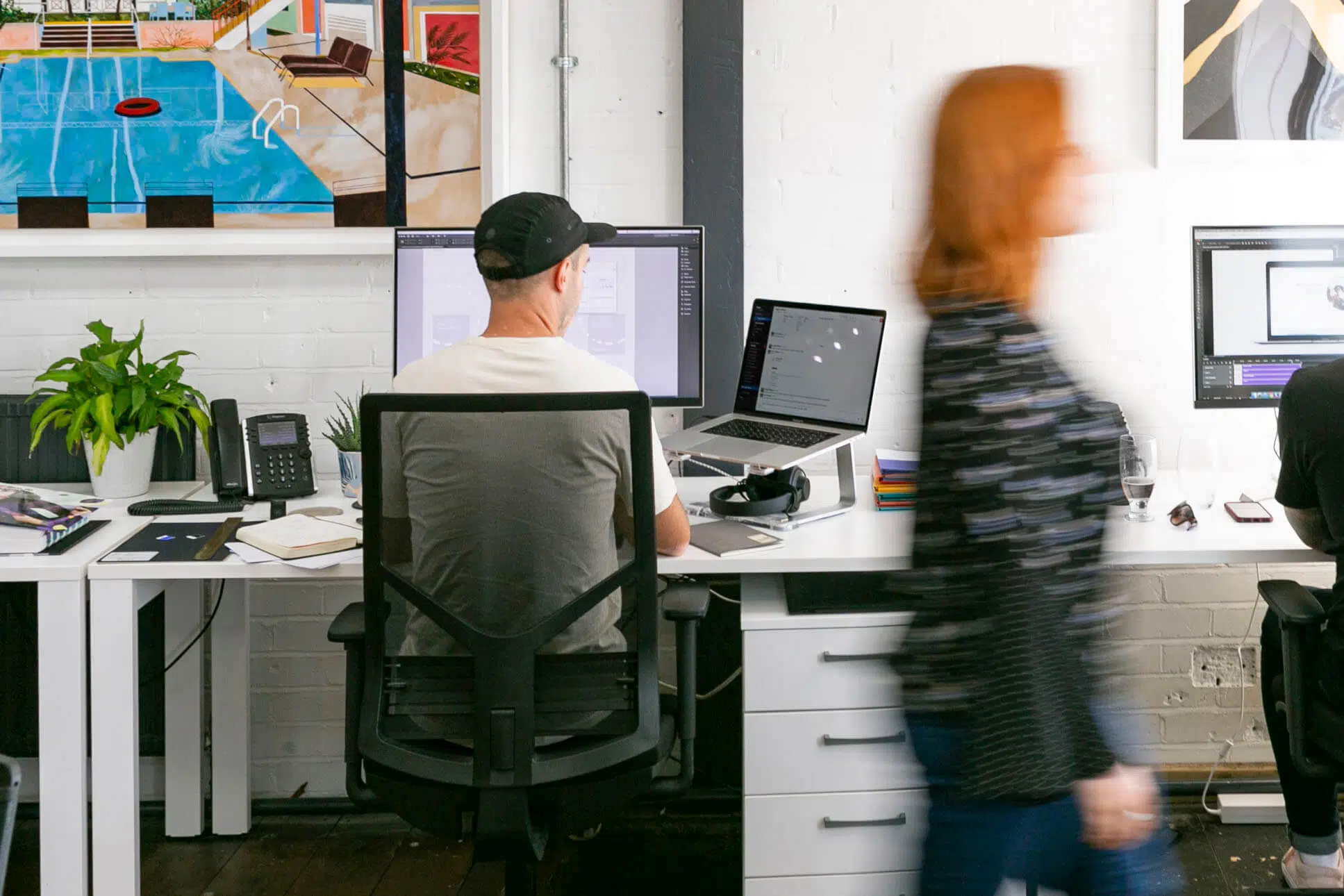 Member of staff walking past a desk