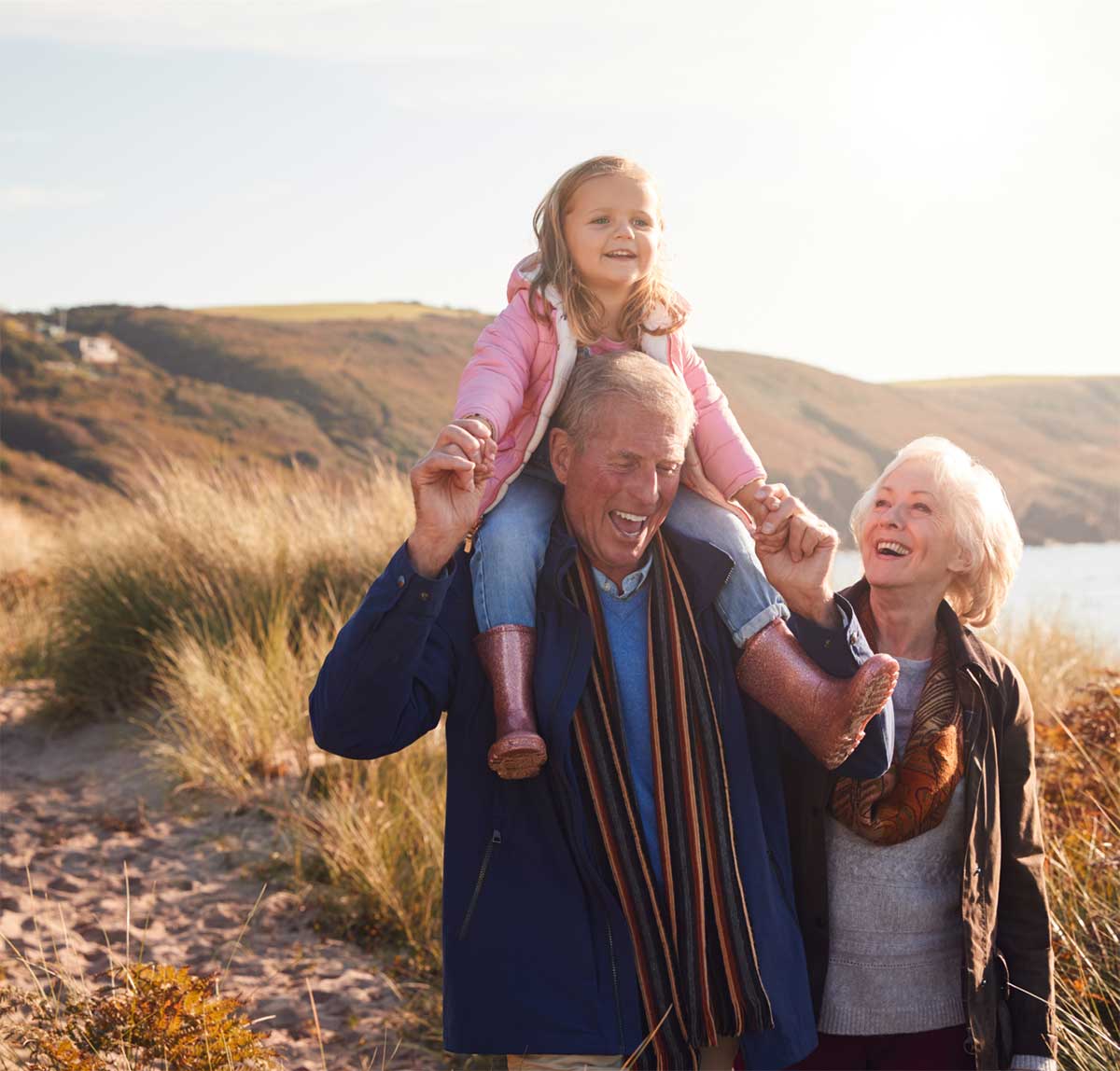grandparents and grandchild walking