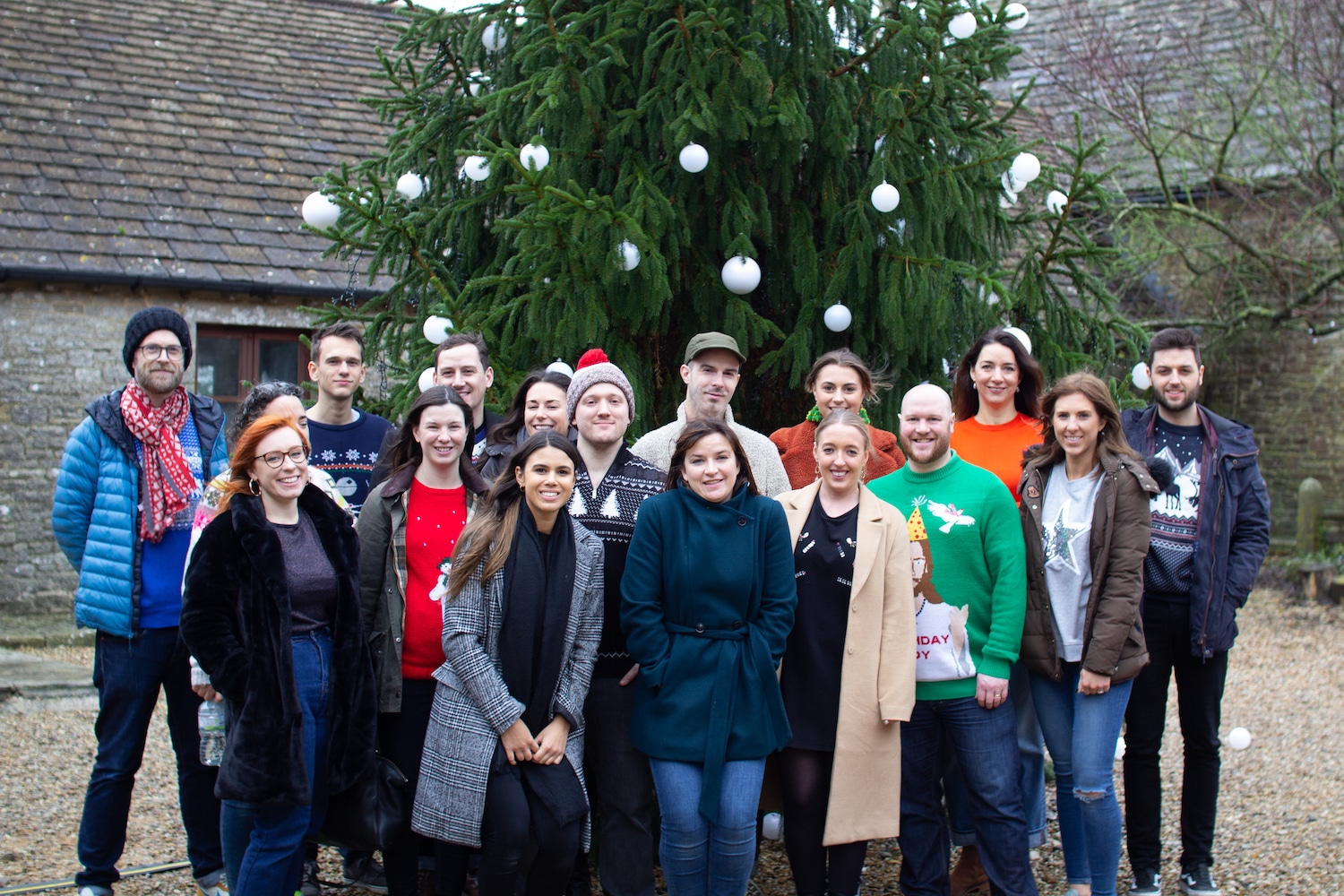 The salad team standing in front of a giant Christmas tree
